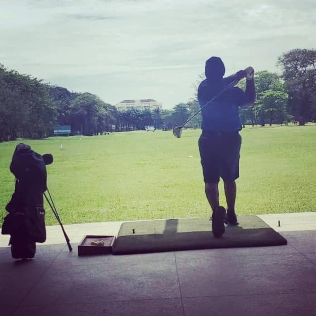 Olukayode following through on a golf swing